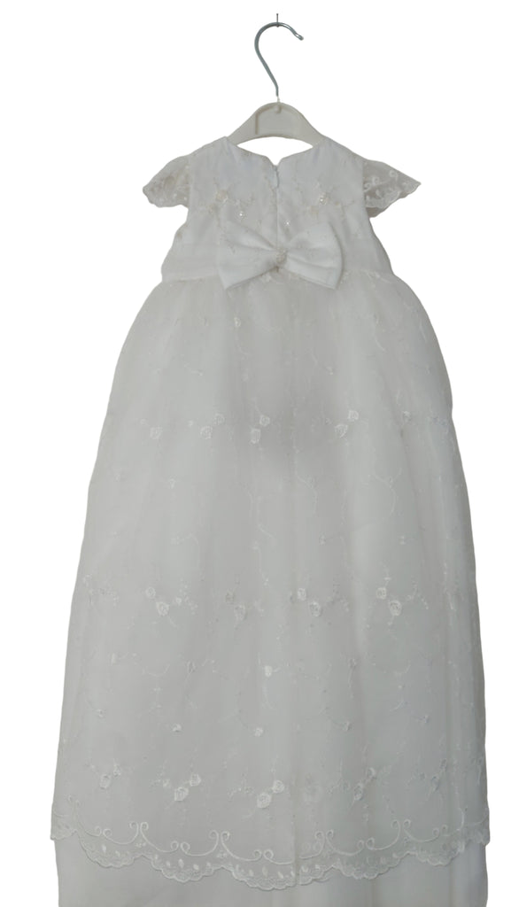 White lace dress on a hanger against a white background