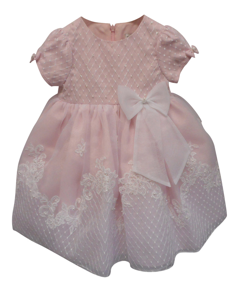 Pink dress with white lace and a large bow on a white background